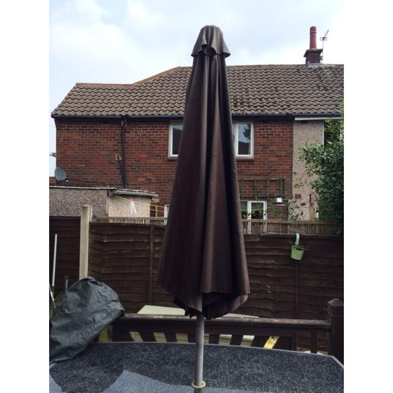 Large glass table and 4 chairs plus parasol and base