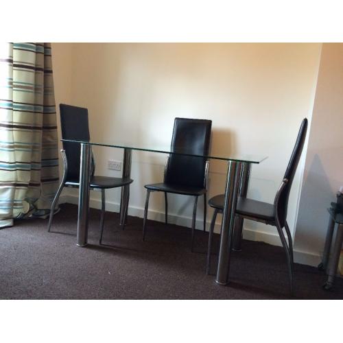 Glass table and 4 chrome and leather look chairs