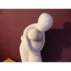 A lovely stone carved ornament of a Mother holding a child