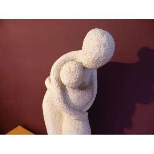 A lovely stone carved ornament of a Mother holding a child