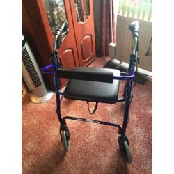 Seated walk frame with wheels