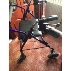 Seated walk frame with wheels