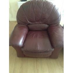 Two large burgundy leather armchairs in good condition.