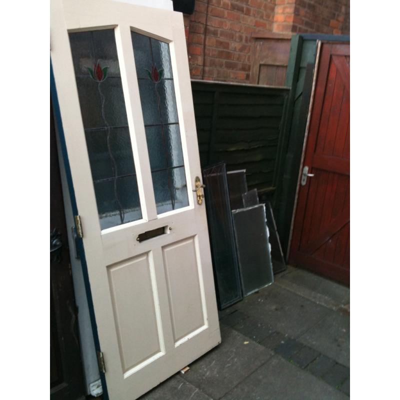 Hardwood door with frosted glass panels and lead decoration over the top