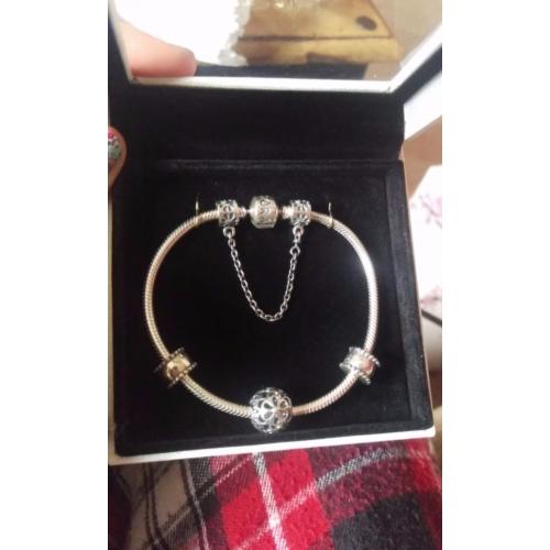NBW Pandora bracelet, with charm, safety chain and 2 spaces.