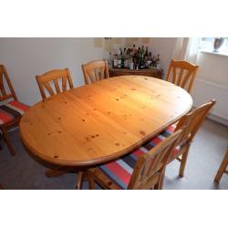 Extending Ikea pine dining table and 8 chairs with removable cushions