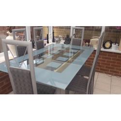 Glass table and six chairs in excellent condition buyer collects