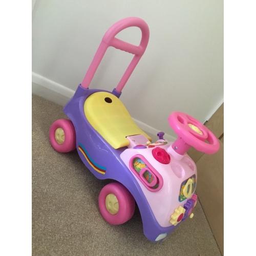 Pink sit on and push along car