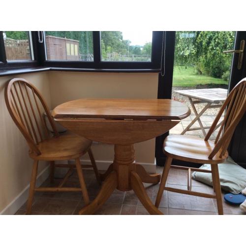 Pine table and two chairs. I good condition with drop leafs. Measuring 3ft wide by 2ft 6 high.