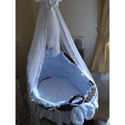 Beautiful brown wicker crib on wheels