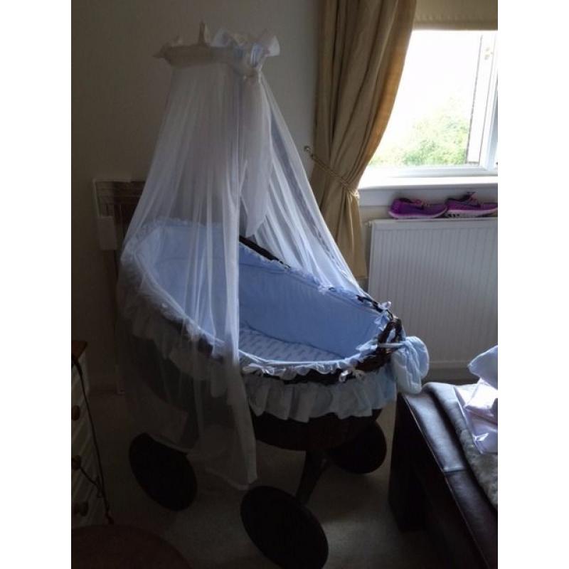 Beautiful brown wicker crib on wheels