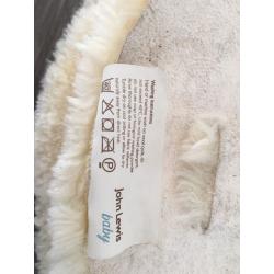 Lambswool liner for pushchair.