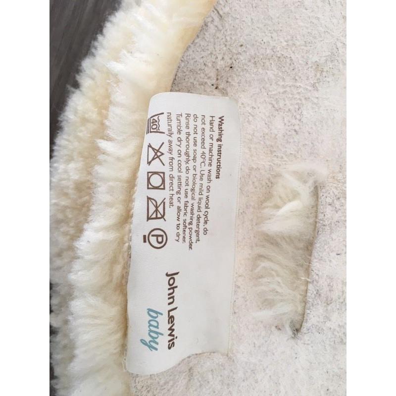 Lambswool liner for pushchair.