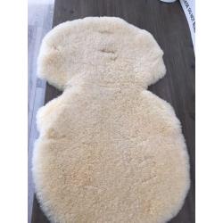 Lambswool liner for pushchair.