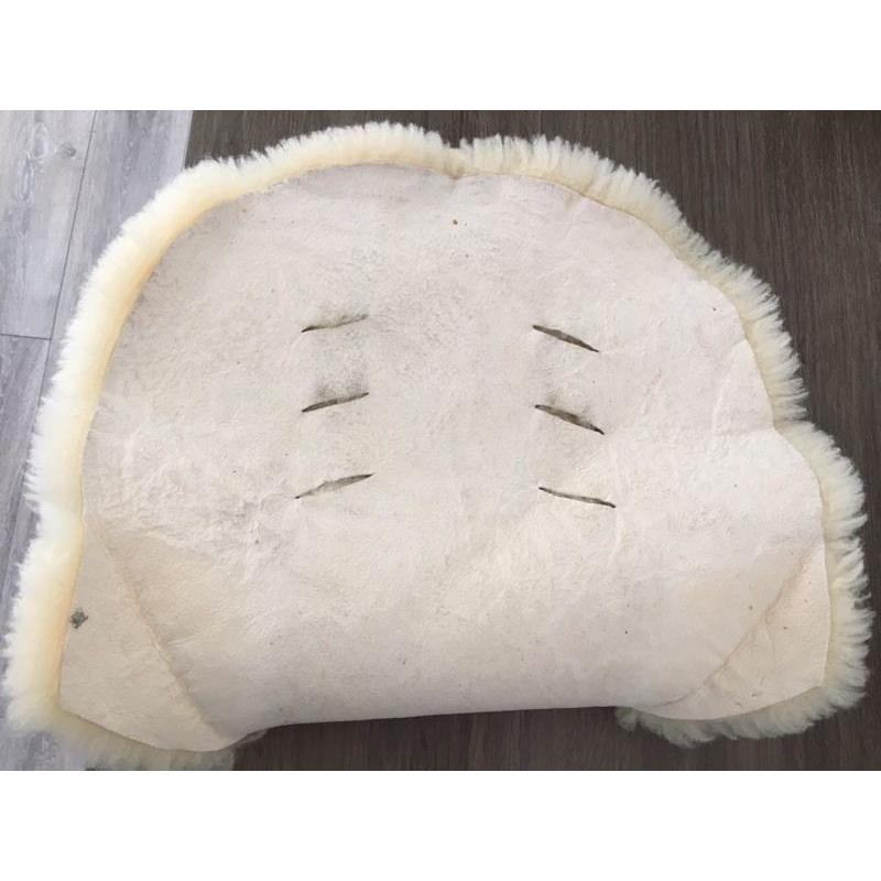 Lambswool liner for pushchair.